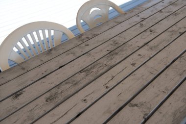 Masa ve sandalyeler güverteye yakın.