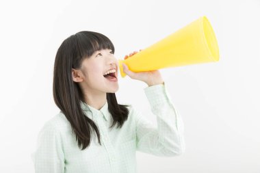 Hoparlörlü gülümseyen Asyalı kızın stüdyo portresi