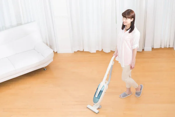 young woman in the room doing housework