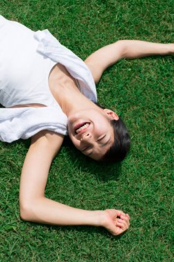 young girl lying on the lawn