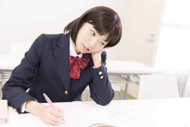 Asyalı kadın öğrenci üniversitede öğreniyor.