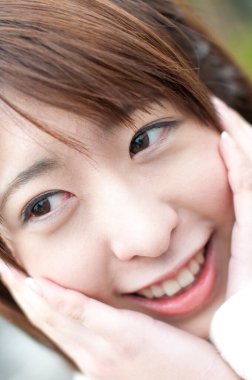Genç Japon kız gülümsüyor.