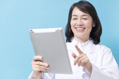 Dijital tabletle gülümseyen kadın doktor