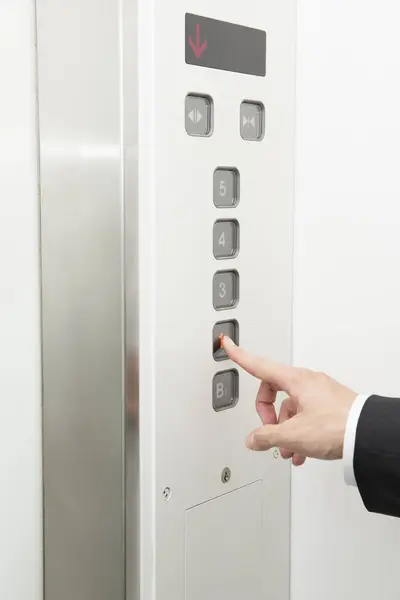 male hand pressing elevator button