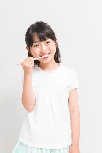 stock image asian girl holding a toothbrush