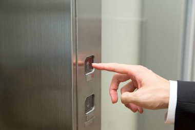 Erkek el asansör düğmesine basıyor