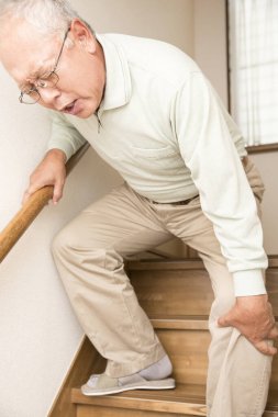 asian elderly man suffering from knee pain 