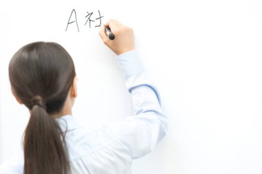 Asyalı kadın beyaz tahtaya resim çiziyor