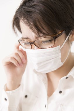 Koruyucu maske takan hasta Asyalı kadın. 