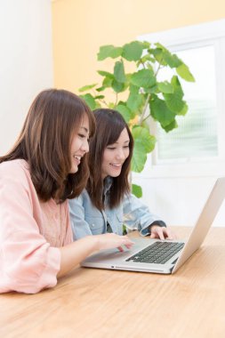 young asian  women with laptop at desk 