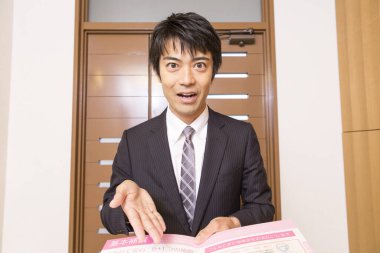 portrait of young asian businessman showing document  clipart