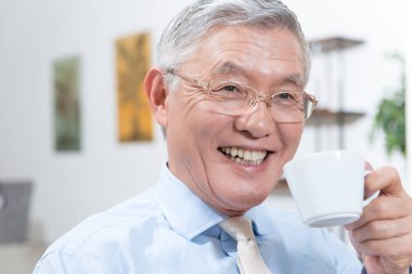 Büyük adam kahve içiyor.