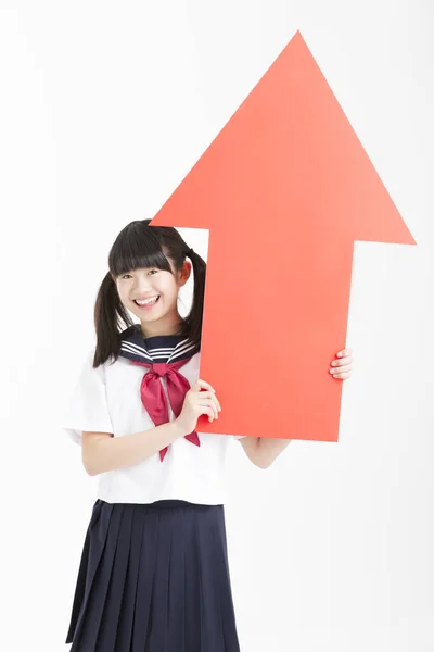 Malá Asijská Dívka Školní Uniformě Drží Červenou Šipku Znamení Izolované — Stock fotografie