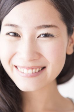 Asyalı bir kadının gülümseyen portresini yakından çek.