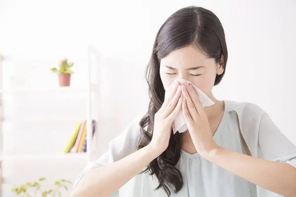 young asian woman with a allergy at home