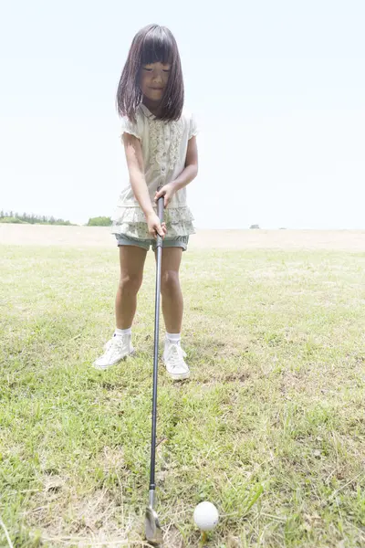 Parkta golf oynayan Asyalı kız.