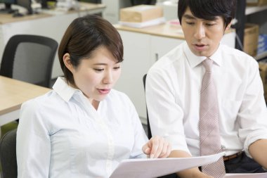 Ofiste belgelerle çalışan iş adamları.