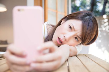 young woman taking a selfie with her smart phone