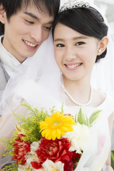 portrait of happy young Asian bride and groom