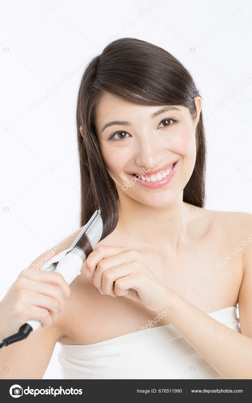 Beautiful Japanese Woman Curling Long Hair Using Curling Iron Stock