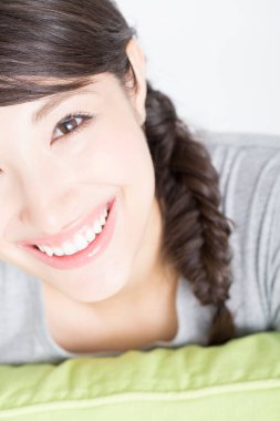  Genç Asyalı kadın yatakta dinleniyor.