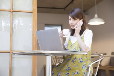 asian woman working at home in kitchen