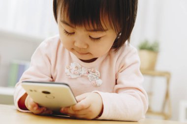 Evde akıllı telefonu olan tatlı bir Japon kız.