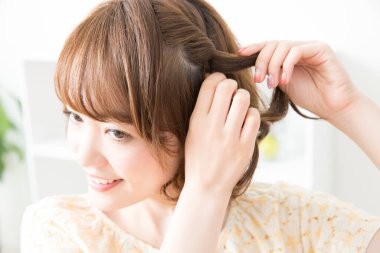 Gülümseyen Asyalı kadın örgü örüyor, kapat.