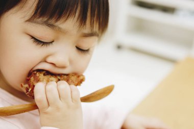 Güzel Asyalı kız evde Japon yemeği yiyor.