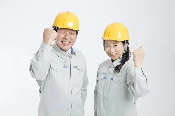 Asian Senior Workers Showing Fists Standing White Wall — Stock Photo, Image