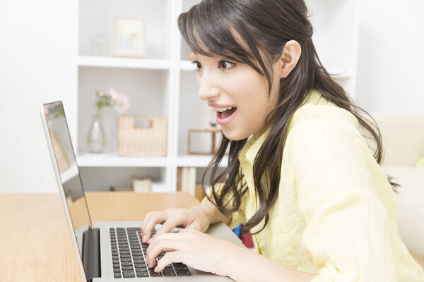 happy young woman with a laptop working