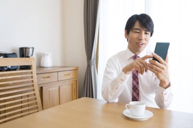 businessman using smart phone on kitchen