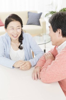 Asyalı son sınıf çifti odada oturuyor.