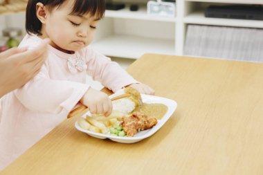 Güzel Asyalı kız evde Japon yemeği yiyor.