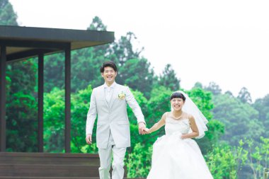 Parkta poz veren Asyalı gelin ve damat 