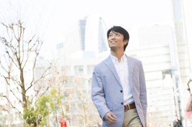 Asya işadamı şehirde yürüyüş