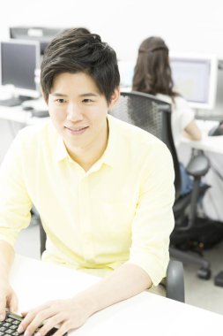 Ofiste bilgisayar kullanan genç adam 