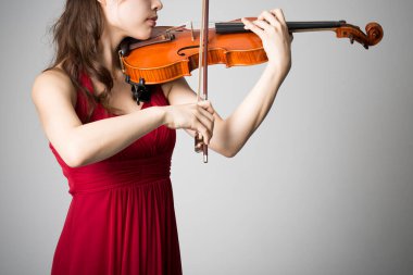 Kadın kemanla poz veriyor. Yakın plan.