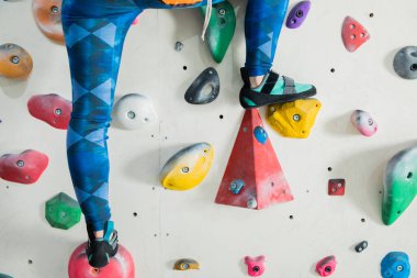 girl climbing wall in the gym 