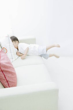 Delikanlı evdeki kanepede uyuyor.