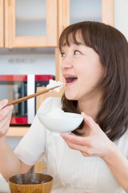 asian  woman eating rice close up