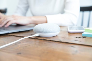 close up of female charging speaker at workplace