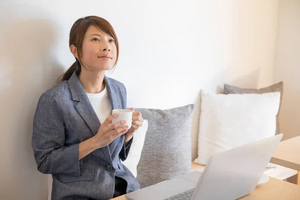 stock image young woman working  with coffee cup