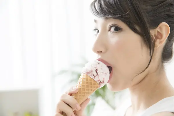 portrait of woman eating ice cream at home