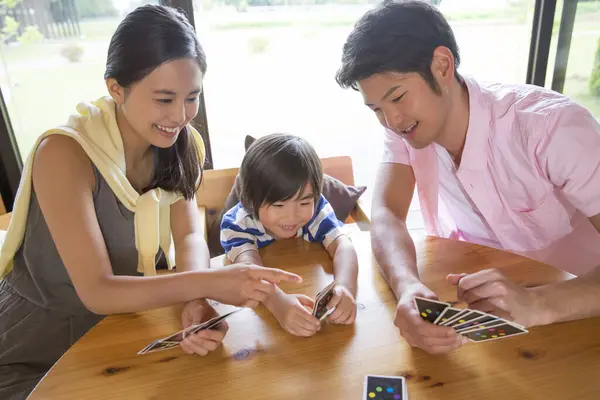 Χαρούμενη Ασιατική Νεαρή Οικογένεια Παίζει Χαρτιά — Φωτογραφία Αρχείου