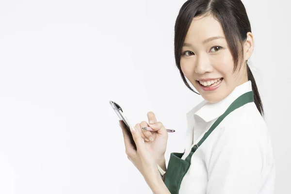 Uśmiechnięta Azjatycka Kelnerka Pisze Kolejność Notatniku — Zdjęcie stockowe