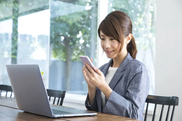 stock image businesswoman using mobile phone at work 