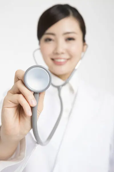Asian Female Doctor Holding Stethoscope White Background — Stock Photo, Image