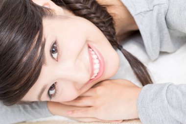 Genç Asyalı kadın kanepeye uzandı.