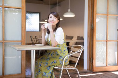 young asian woman with coffee in cafe